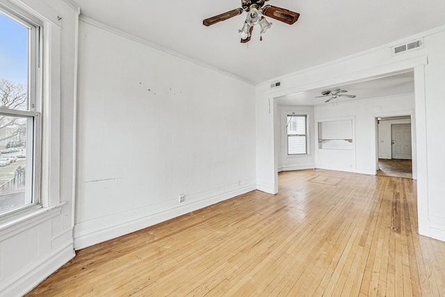 spare room featuring ceiling fan, ornamental molding, and light hardwood / wood-style floors