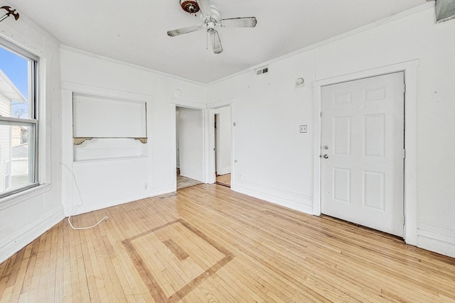 unfurnished room with light hardwood / wood-style flooring, ceiling fan, and ornamental molding