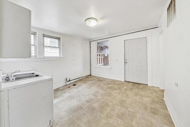 kitchen featuring sink, white cabinets, and plenty of natural light