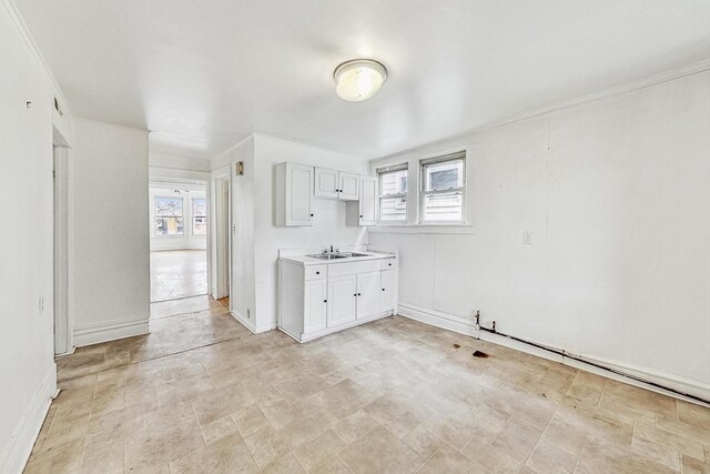 kitchen featuring sink and white cabinetry