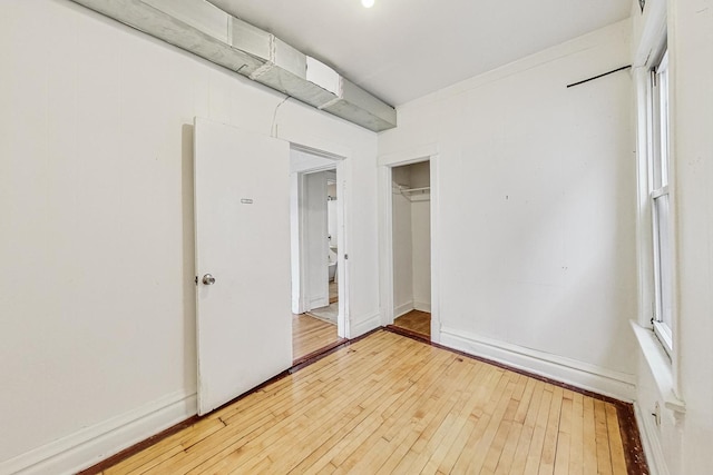 unfurnished bedroom with hardwood / wood-style floors and a closet