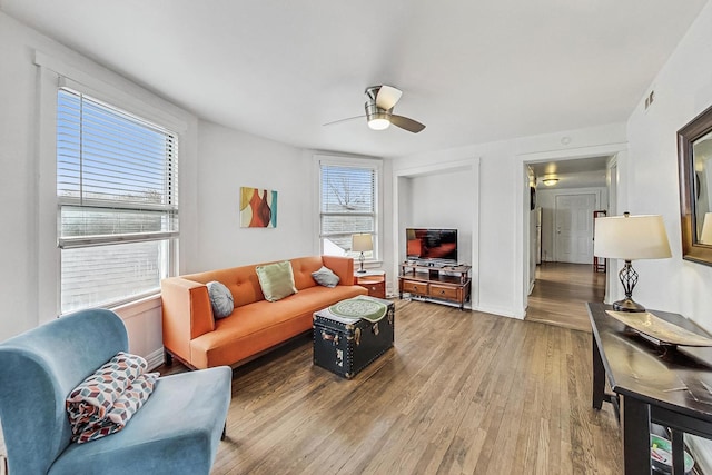 living room with ceiling fan, hardwood / wood-style floors, and a healthy amount of sunlight