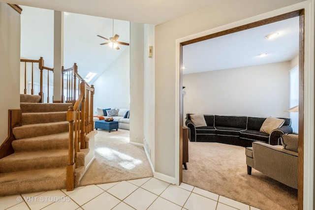 carpeted living room with ceiling fan