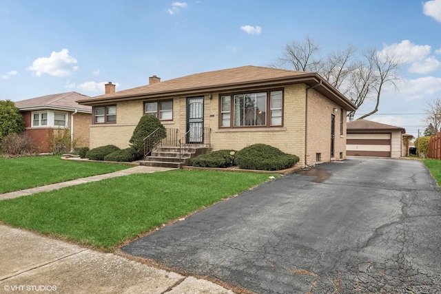 view of front of property with a garage, a front yard, and an outdoor structure