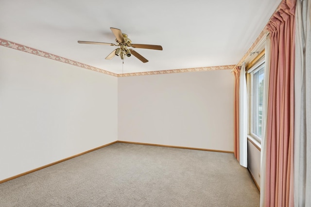 spare room featuring ceiling fan and light colored carpet