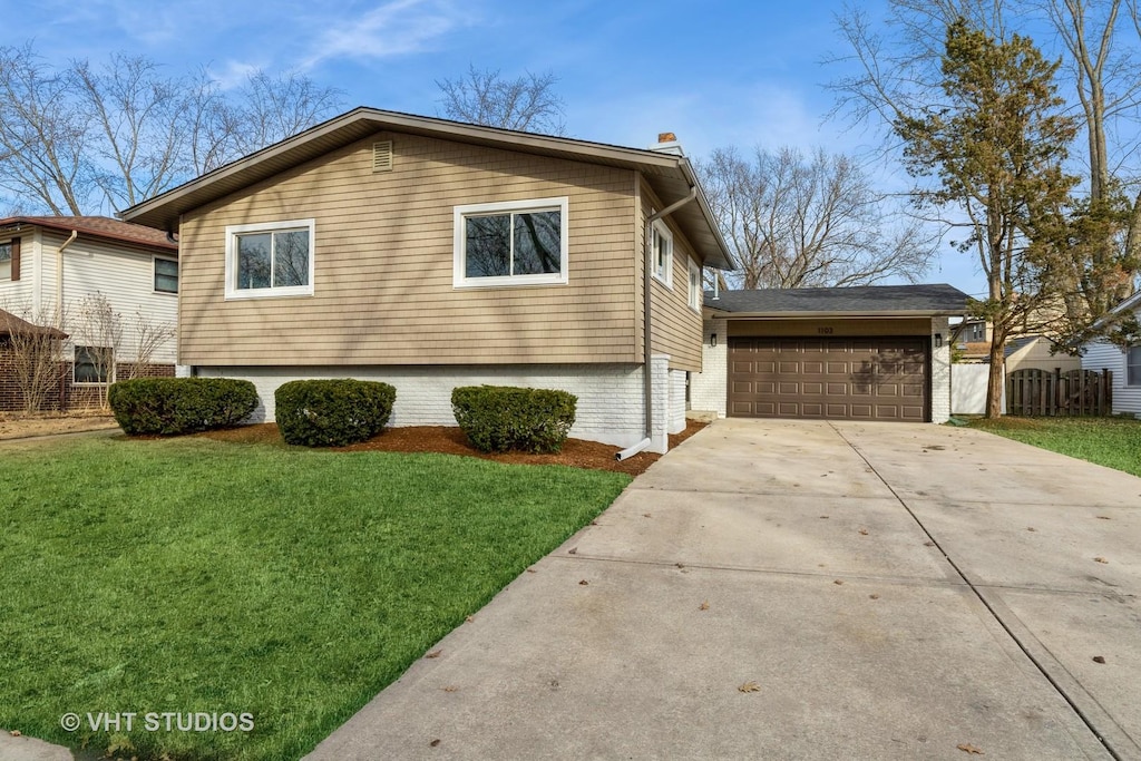 view of front of property with a garage and a front yard