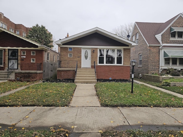 bungalow-style house with a front yard