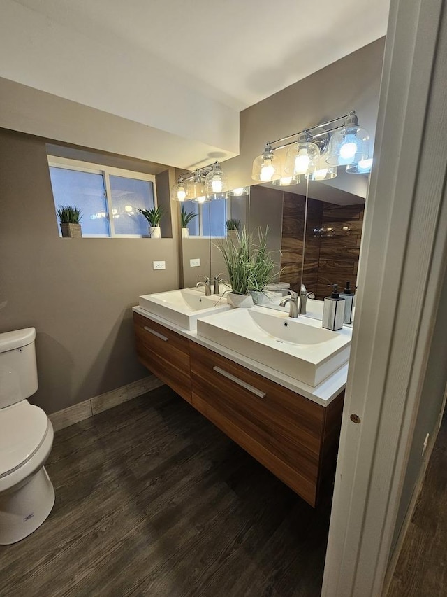 bathroom featuring toilet, hardwood / wood-style flooring, and vanity