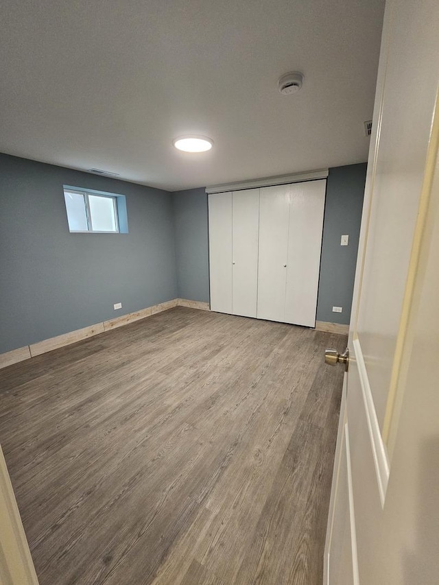 unfurnished bedroom with a closet and hardwood / wood-style floors