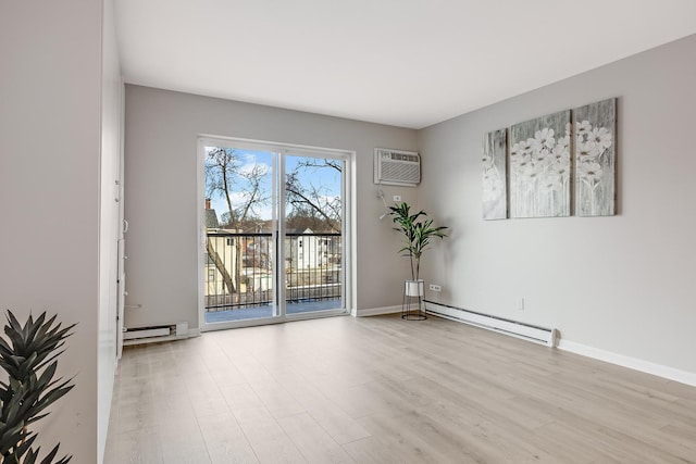 empty room featuring a baseboard heating unit, light hardwood / wood-style flooring, and an AC wall unit