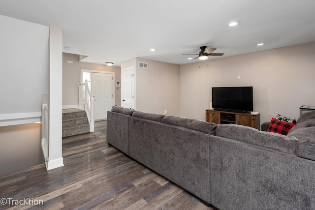 living room with dark hardwood / wood-style floors and ceiling fan