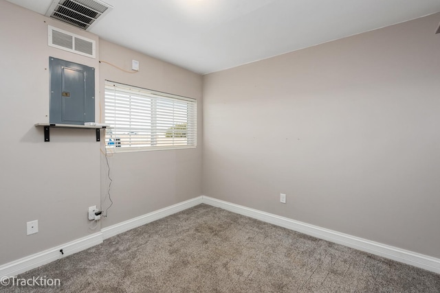 carpeted empty room featuring electric panel