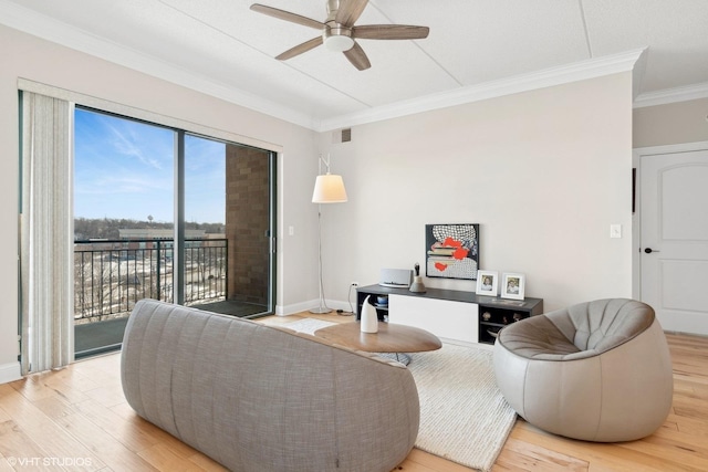 living room featuring hardwood / wood-style flooring, ceiling fan, and crown molding