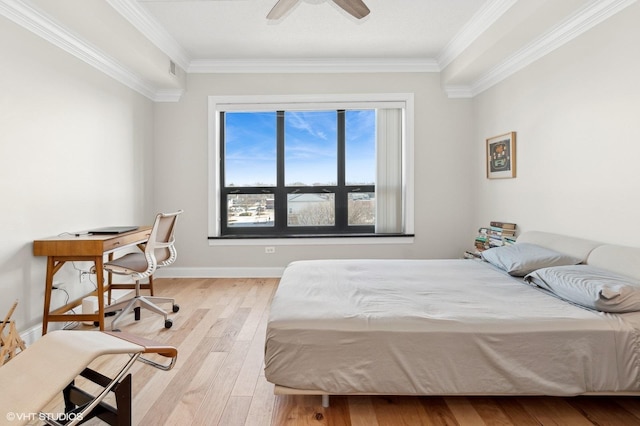 bedroom featuring light hardwood / wood-style flooring, ornamental molding, and ceiling fan