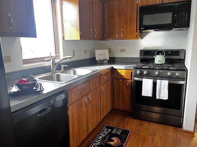 kitchen with dark hardwood / wood-style flooring, sink, and black appliances