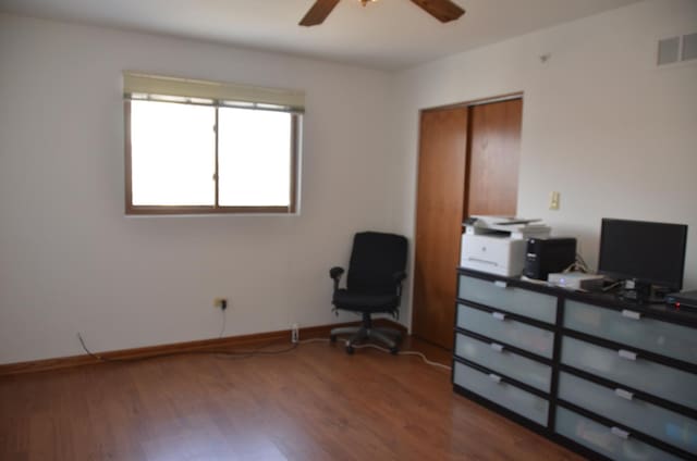 interior space with wood-type flooring and ceiling fan