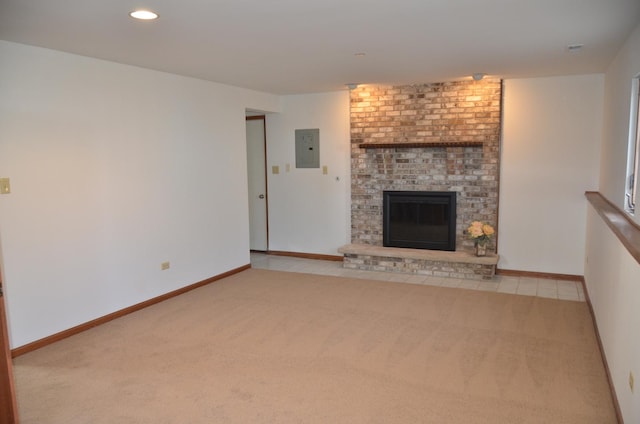 unfurnished living room with a fireplace, electric panel, and light carpet