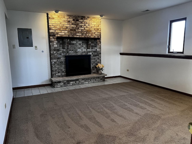 unfurnished living room featuring light colored carpet, electric panel, and a brick fireplace