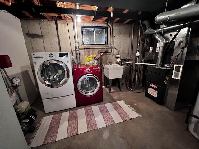 clothes washing area featuring sink and washing machine and dryer