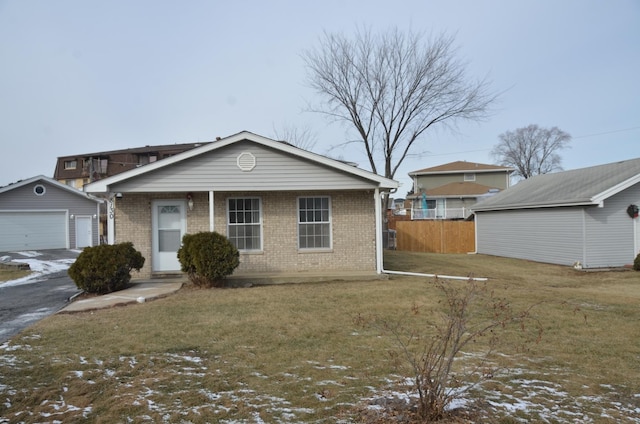 view of front of house with an outbuilding, a garage, and a lawn