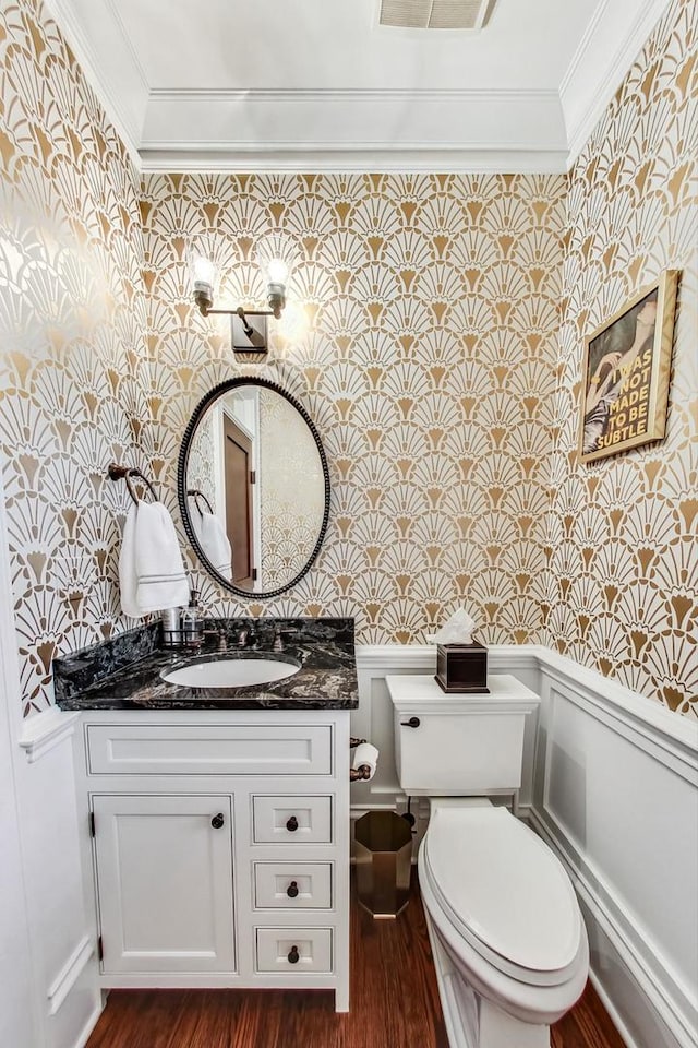 bathroom with toilet, ornamental molding, hardwood / wood-style flooring, and vanity