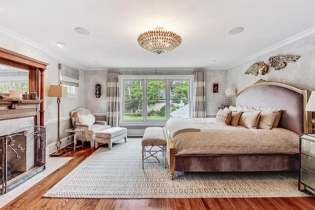 bedroom featuring wood-type flooring and crown molding