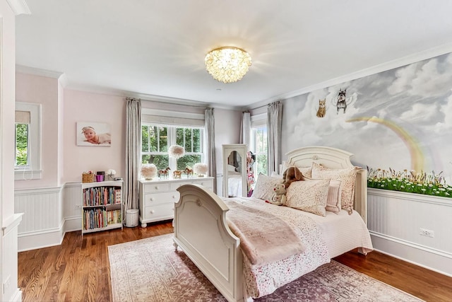 bedroom with ornamental molding, a chandelier, and wood-type flooring