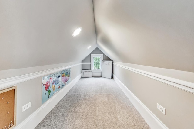 interior space featuring carpet and vaulted ceiling