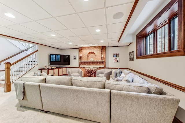 living room featuring carpet flooring and a drop ceiling