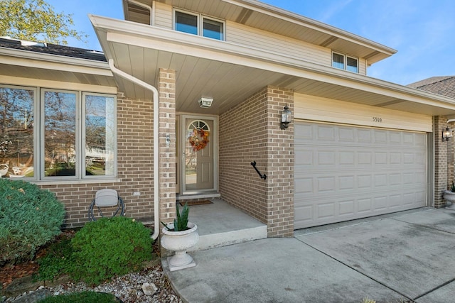 doorway to property with a garage