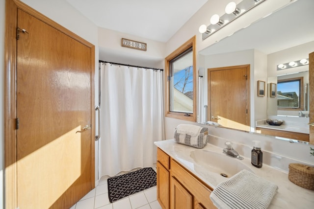 bathroom with vanity, plenty of natural light, and tile patterned floors