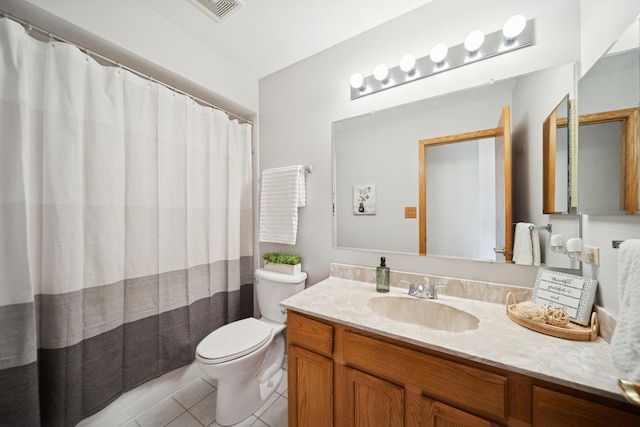 bathroom featuring vanity, toilet, and tile patterned flooring