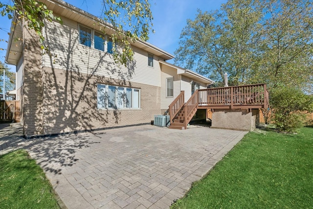 back of house with a wooden deck, a yard, central AC, and a patio area