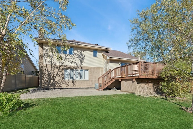 rear view of house featuring a wooden deck, a patio area, central air condition unit, and a lawn