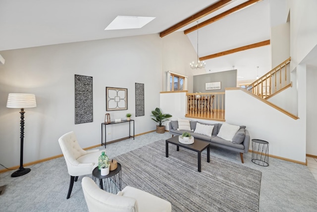 carpeted living room with beamed ceiling, a skylight, a chandelier, and high vaulted ceiling