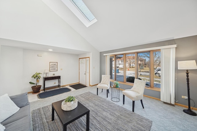 living room with carpet flooring, a skylight, and high vaulted ceiling