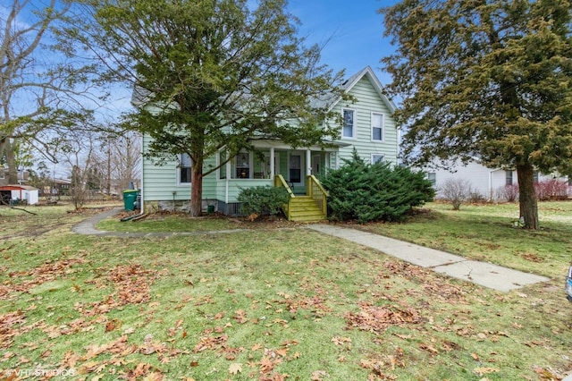 view of property hidden behind natural elements featuring a front lawn