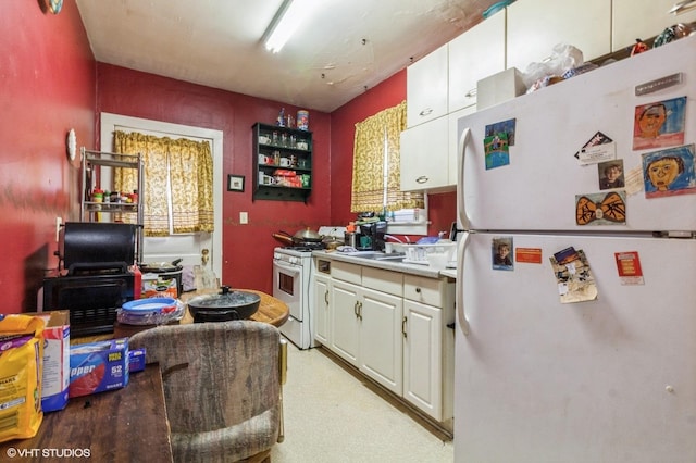 kitchen featuring white cabinets, white appliances, and light hardwood / wood-style floors