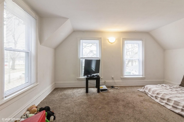 carpeted bedroom featuring lofted ceiling