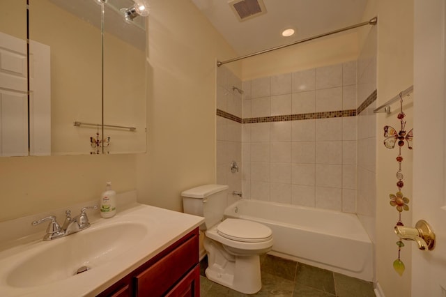 full bathroom featuring toilet, tiled shower / bath combo, tile patterned floors, and vanity