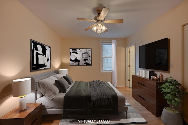 bedroom with ceiling fan and light hardwood / wood-style floors