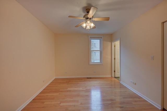 empty room with ceiling fan and light wood-type flooring