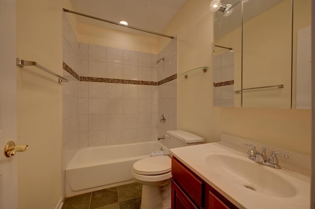 full bathroom with toilet, vanity, and tiled shower / bath