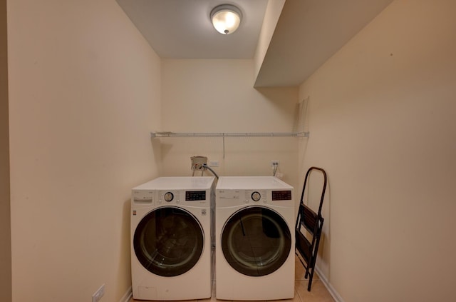 clothes washing area featuring independent washer and dryer and light tile patterned flooring