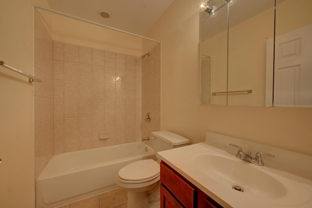 full bathroom featuring toilet, vanity, tile patterned flooring, and tiled shower / bath