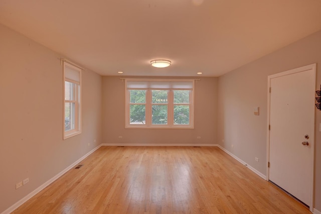 spare room with light wood-type flooring