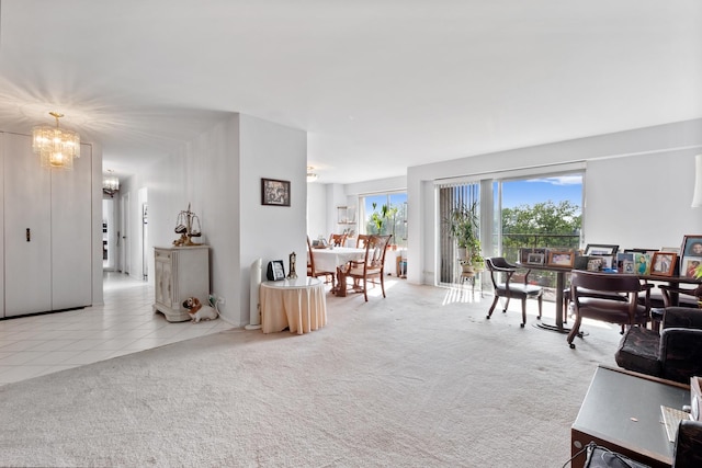 living room featuring light colored carpet and a chandelier