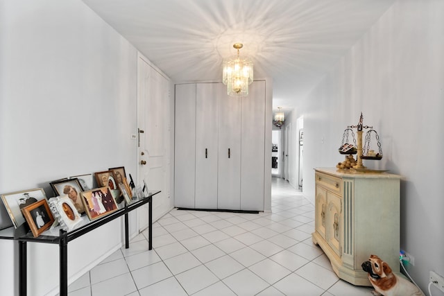 foyer with light tile patterned flooring and a chandelier