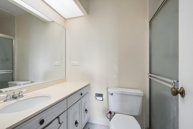 bathroom with tile patterned floors, walk in shower, vanity, and toilet