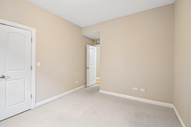 spare room featuring light colored carpet